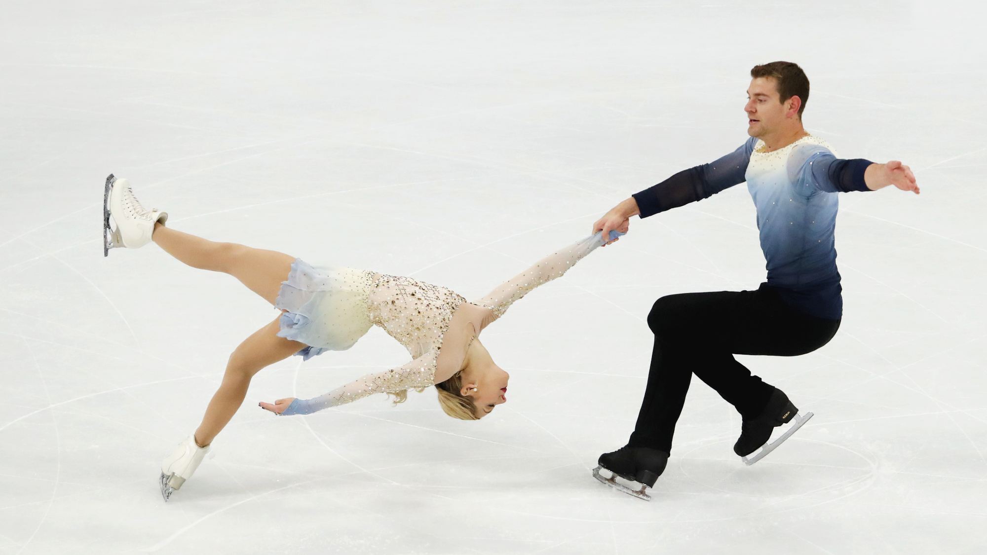 Madison Chock and Evan Bates performing at the 2026 Winter Olympics during the ice dancing scandal.