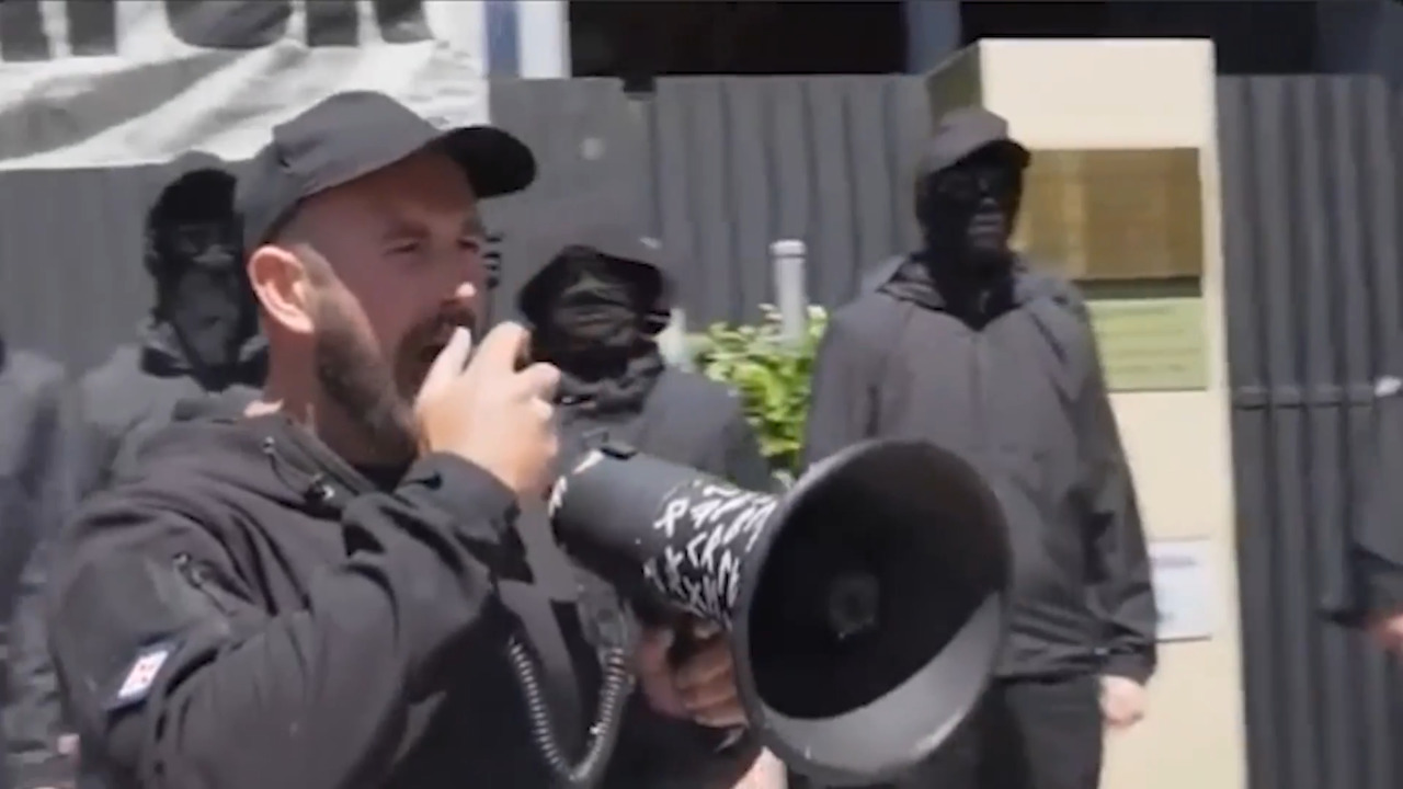 AFP officers and Australian Border Force conducting a digital device search at Brisbane Airport.