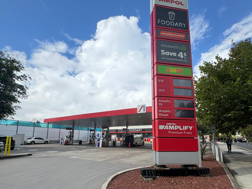 A crowded NSW service station with "Out of Diesel" signs during the 2026 global fuel crisis.