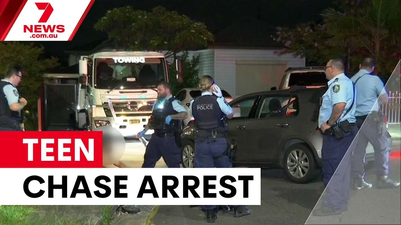 Police tape and fire rescue crews at the scene of a burnt-out Audi sedan in Merrylands, Western Sydney.