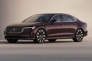 The sleek 2026 Volvo EX90 electric SUV in a minimalist Scandinavian setting, showing off its 'Thor’s Hammer' headlights.