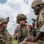 A young man looking at a digital notification on his smartphone about Selective Service registration.