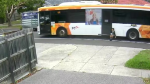 Still shot from the distressing footage of a Melbourne bus with a child trapped in the closing doors.