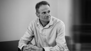 Professor Richard Scolyer smiling during a health update interview about his brain cancer journey in 2026.