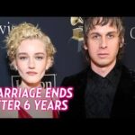 Actress Julia Garner and musician Mark Foster posing together smiling at a Hollywood red carpet event.