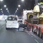 Dashcam frame showing motorcyclist dragged by oversized truck in Melbourne tunnel.